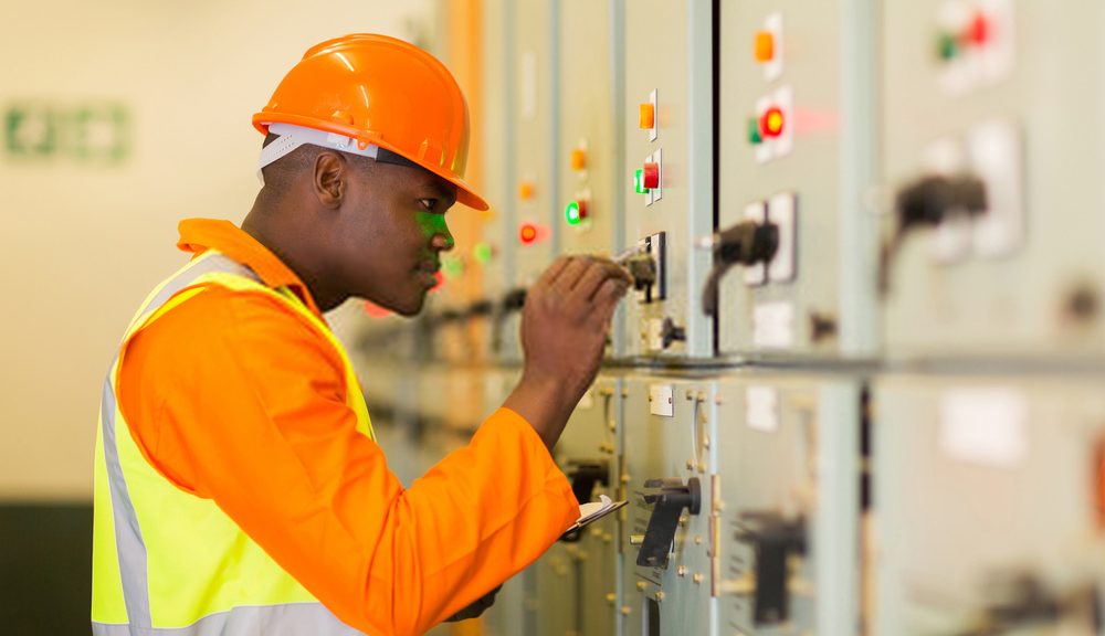 Abuja ELectricity Distribution Company (AEDC) Staff working on an electric circuit.